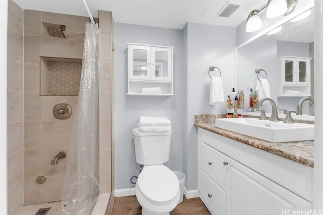 bathroom featuring toilet, a shower with curtain, and vanity