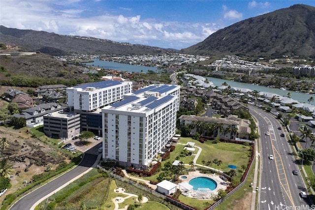 birds eye view of property with a water and mountain view