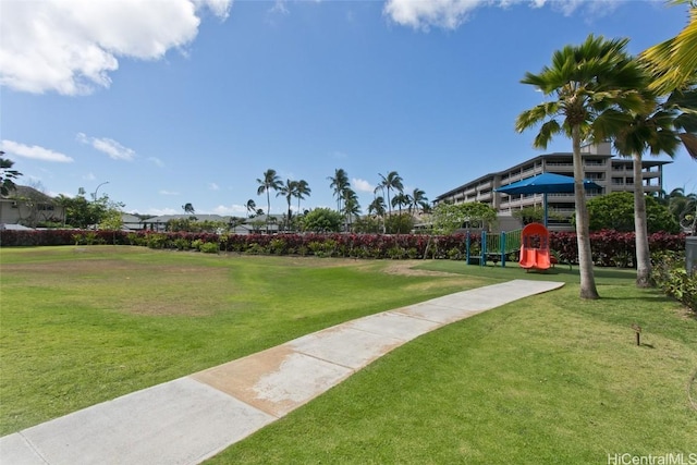 surrounding community featuring a playground and a lawn