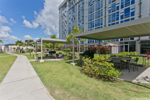 view of community featuring a patio area and a lawn