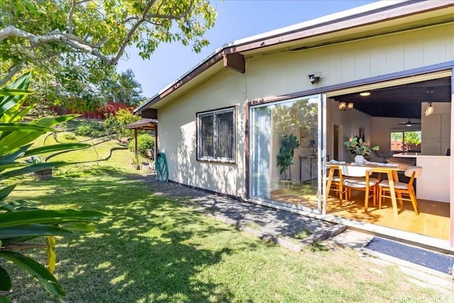 view of side of property featuring a patio and a yard