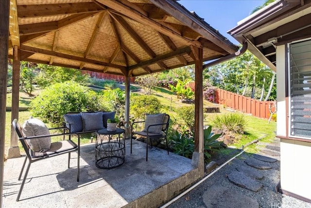 view of patio / terrace featuring a gazebo, an outdoor hangout area, and fence