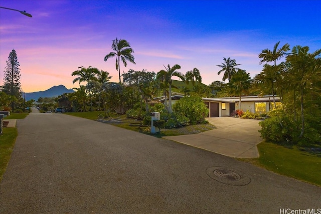 view of front of property featuring a mountain view, concrete driveway, and an attached garage