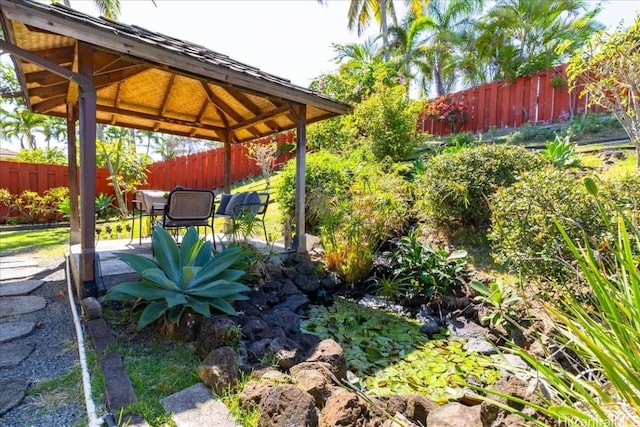 exterior space featuring a gazebo, fence, and a patio