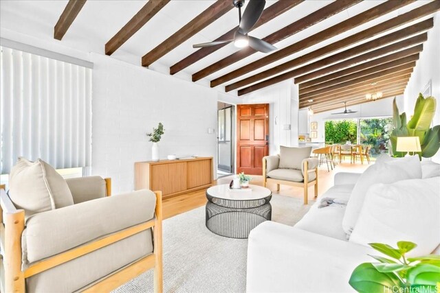 living area with lofted ceiling with beams, wood finished floors, and a ceiling fan