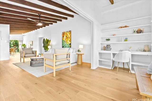 living area with wood finished floors and beamed ceiling