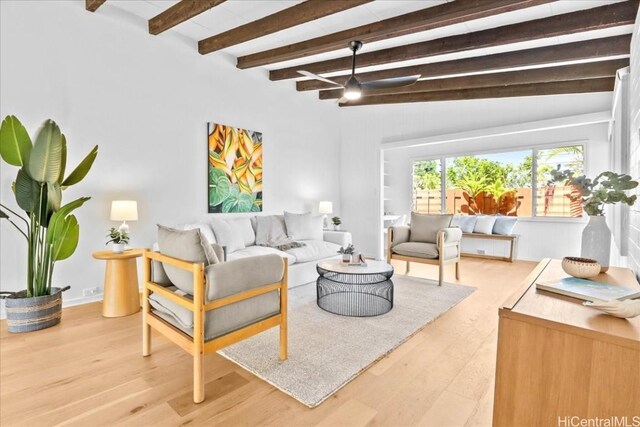 living room with a ceiling fan, vaulted ceiling with beams, and wood finished floors