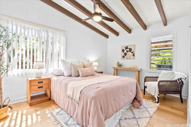 bedroom featuring a ceiling fan, wood finished floors, and vaulted ceiling with beams