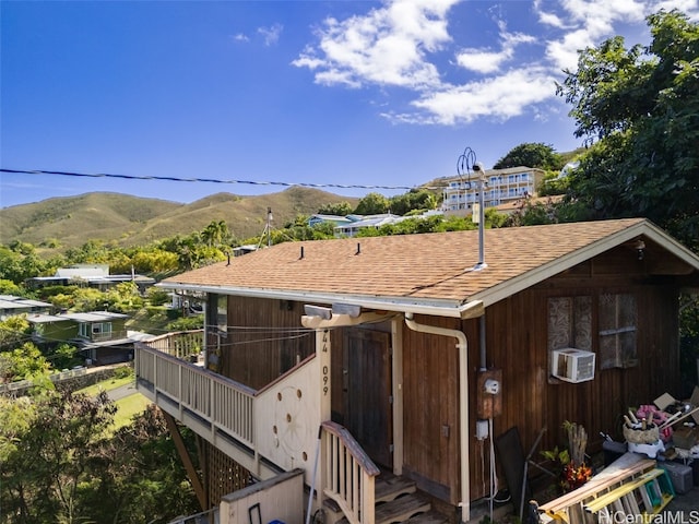 view of side of property with cooling unit and a mountain view