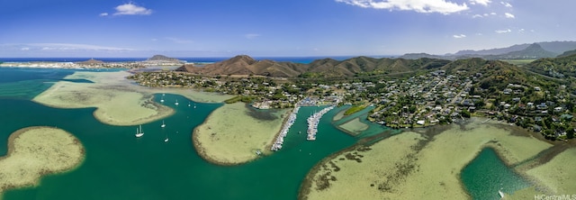 aerial view featuring a water and mountain view