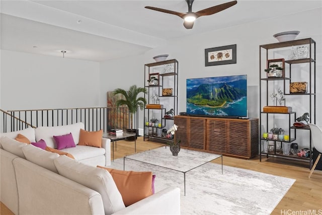 living room featuring wood-type flooring and ceiling fan