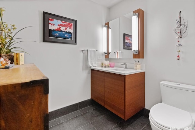 bathroom featuring toilet and vanity