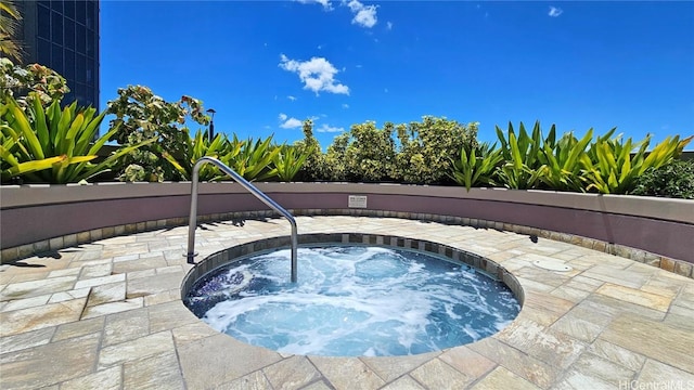 view of pool with a patio area and a community hot tub