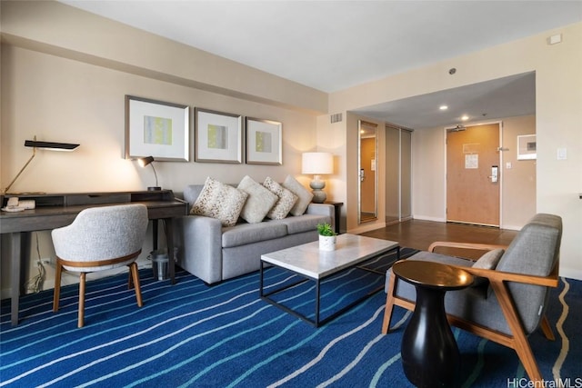 living area featuring visible vents and recessed lighting