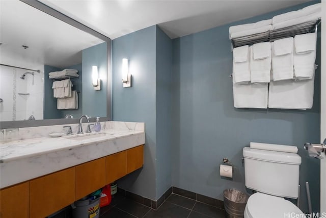 bathroom with toilet, tile patterned flooring, baseboards, and vanity