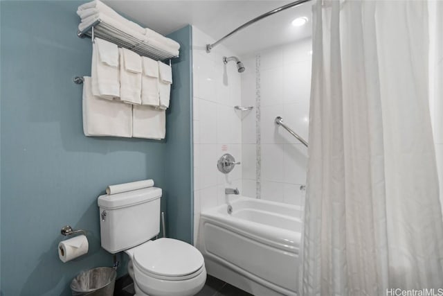 bathroom with toilet and shower / tub combo with curtain