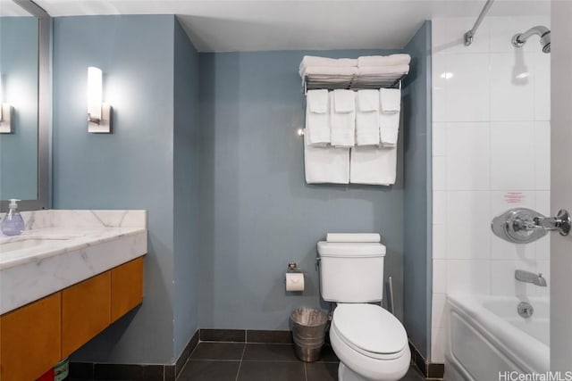 bathroom with toilet, vanity, baseboards,  shower combination, and tile patterned floors