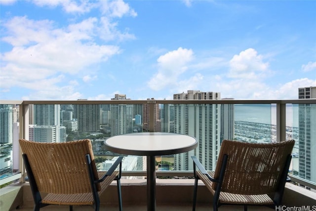 balcony featuring a view of city and a water view