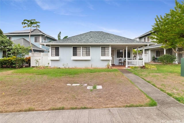 view of front of property with covered porch and a front yard