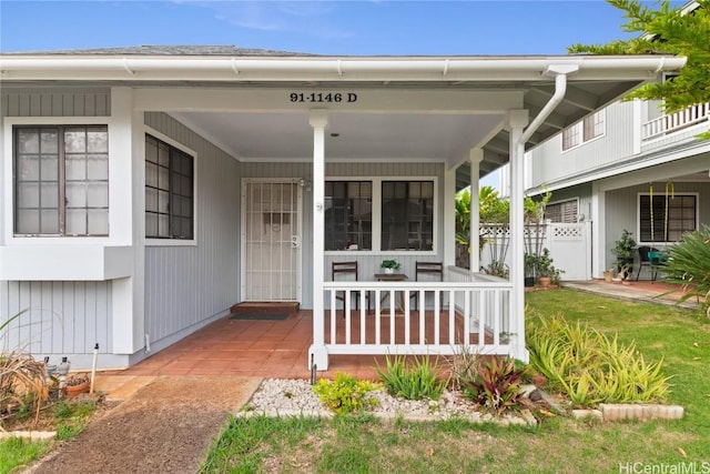 view of exterior entry featuring a porch