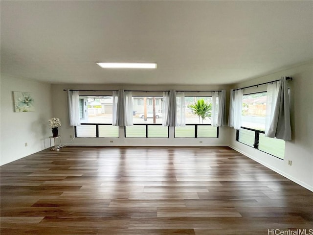 spare room with dark hardwood / wood-style flooring