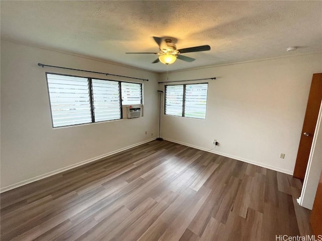 spare room featuring cooling unit, ceiling fan, dark hardwood / wood-style floors, and a textured ceiling