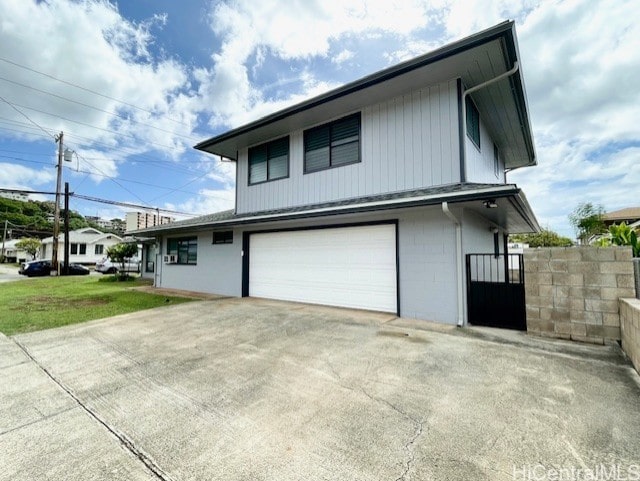 view of side of home with a garage and a yard