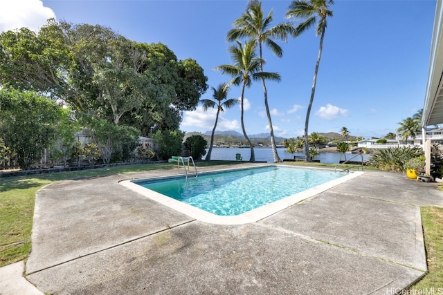 view of pool featuring a patio and a water view