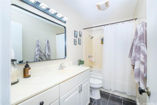 full bathroom featuring toilet, vanity, tile patterned floors, and shower / bath combo with shower curtain