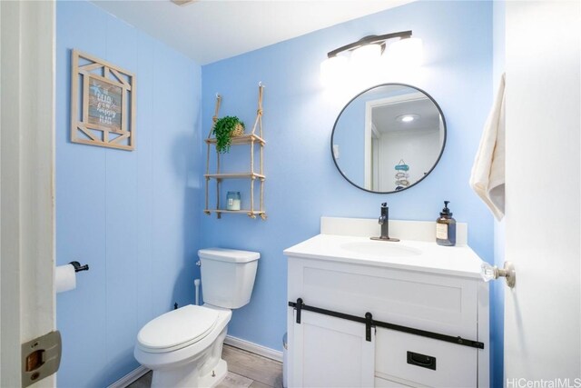 bathroom featuring toilet and vanity