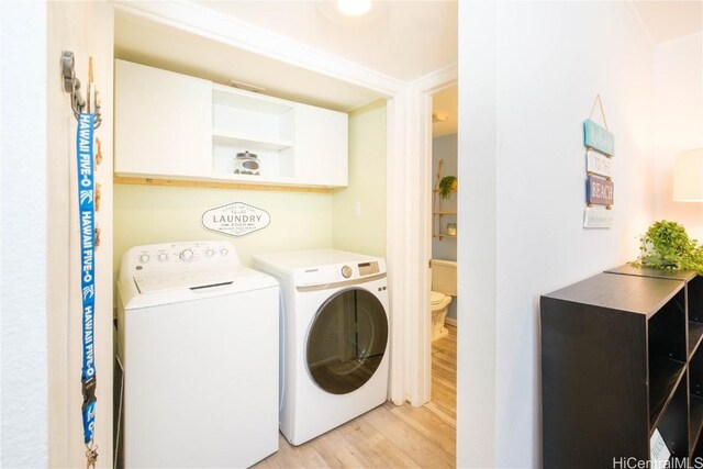 washroom with separate washer and dryer and light hardwood / wood-style flooring