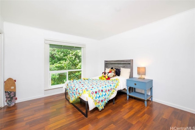 bedroom with dark hardwood / wood-style floors