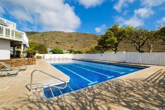 view of swimming pool featuring a mountain view and a patio area