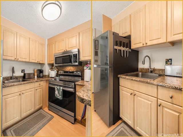 kitchen with a textured ceiling, light hardwood / wood-style floors, sink, and stainless steel appliances