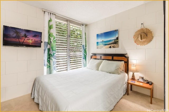 bedroom with light carpet and a textured ceiling