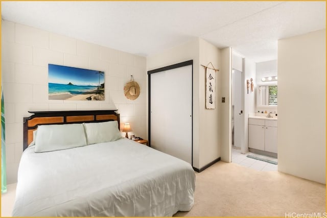 carpeted bedroom featuring connected bathroom