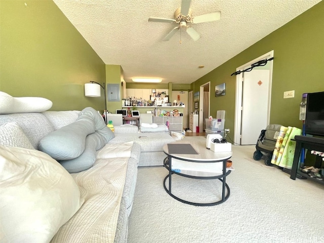 carpeted living room featuring a textured ceiling and ceiling fan