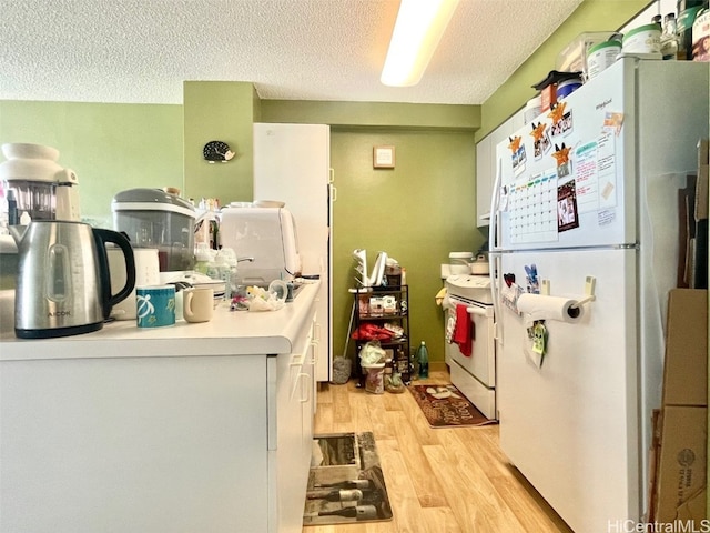 kitchen featuring white cabinetry, white appliances, a textured ceiling, and light hardwood / wood-style flooring