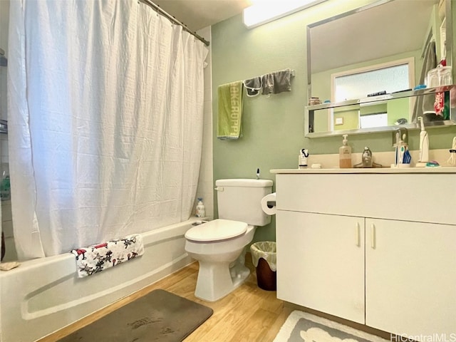 full bathroom featuring vanity, toilet, wood-type flooring, and shower / tub combo with curtain