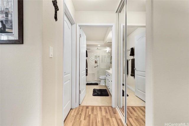 corridor with light hardwood / wood-style floors