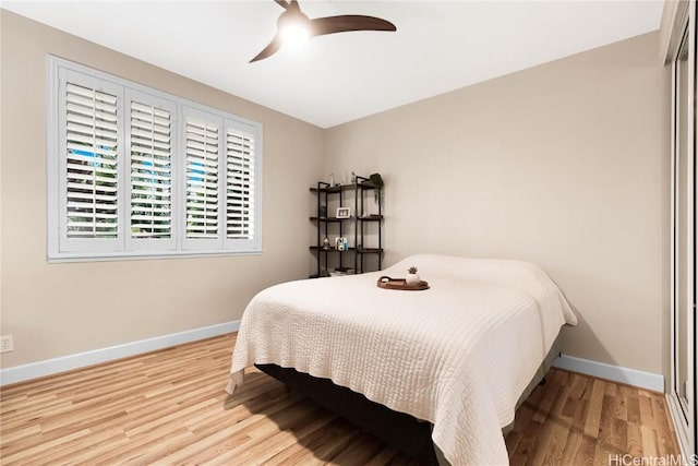 bedroom featuring ceiling fan, light hardwood / wood-style floors, and a closet