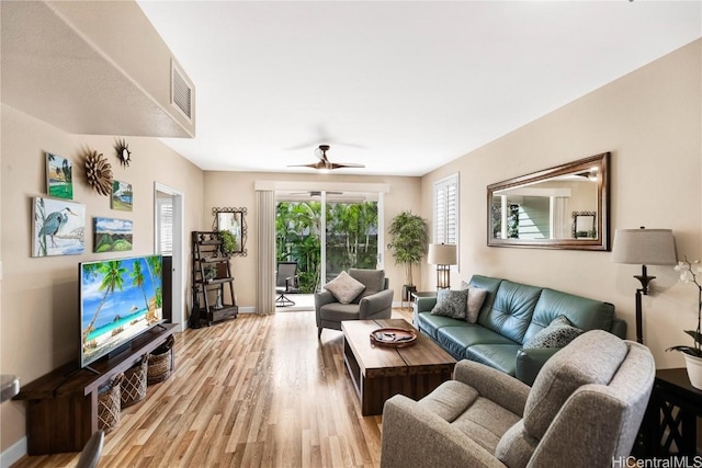 living room featuring ceiling fan and light hardwood / wood-style flooring