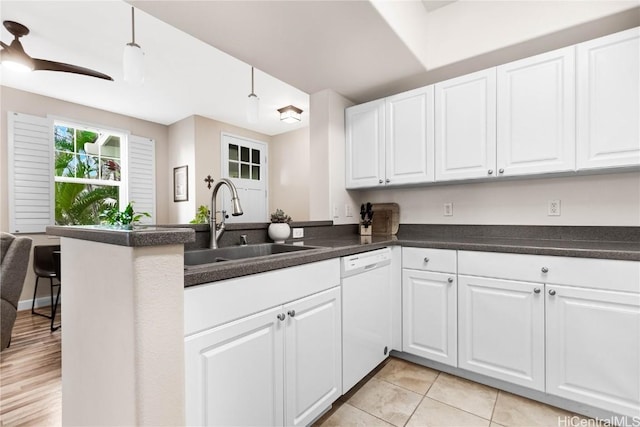 kitchen with white cabinetry, dishwasher, sink, and kitchen peninsula