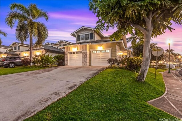 view of front of home with a lawn and a garage