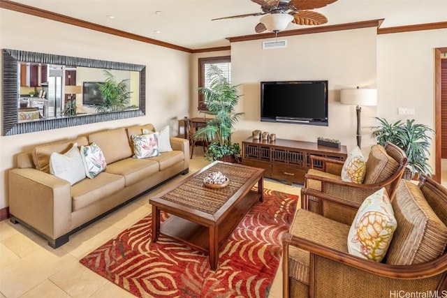 tiled living room with ceiling fan and crown molding