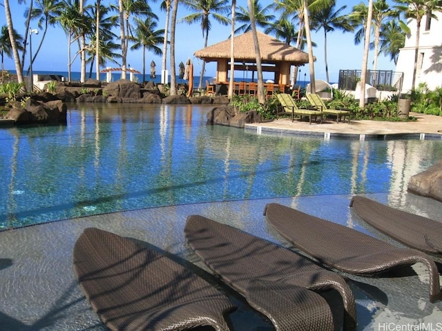 view of swimming pool with a gazebo and a water view