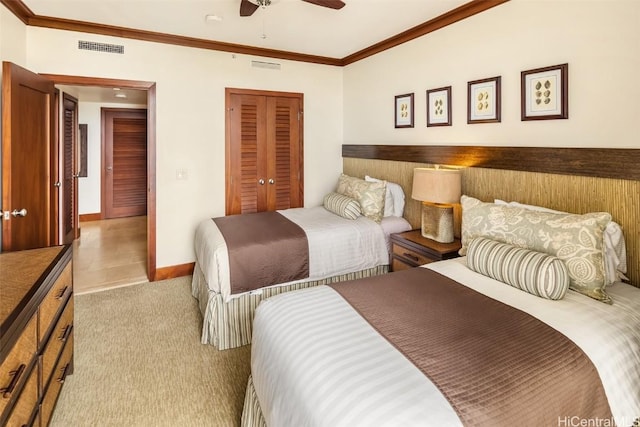 bedroom with a closet, ceiling fan, ornamental molding, and light colored carpet