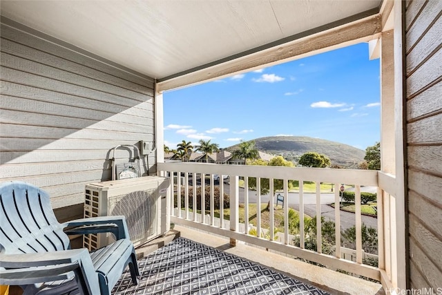 balcony featuring ac unit and a mountain view