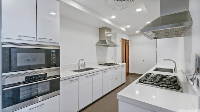 kitchen featuring sink, white cabinetry, stainless steel appliances, island exhaust hood, and wall chimney exhaust hood