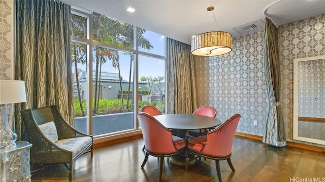 dining room with wood-type flooring and plenty of natural light